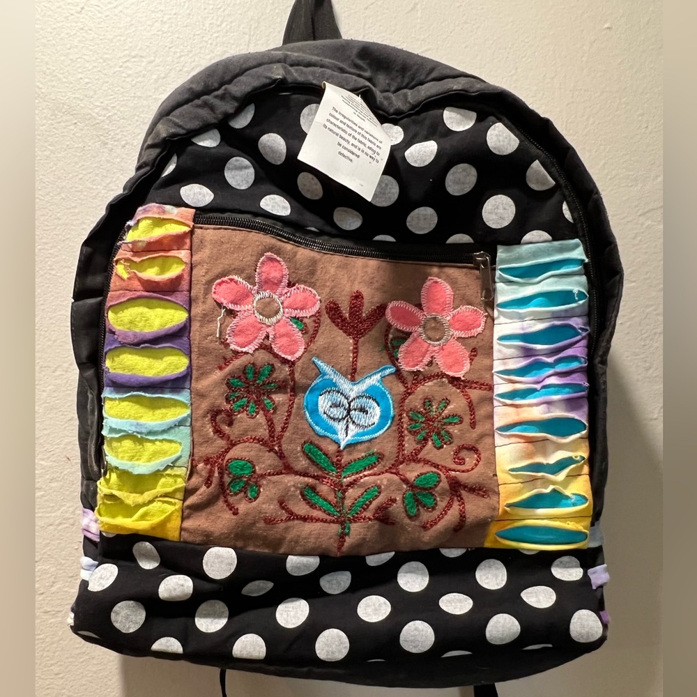 Boho NWT backpack with bright colored materials and a floral print